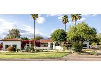 Charming single-story home featuring white stucco, desert landscaping, and a beautiful red tile roof at 10380 E Cholla St, Scottsdale, AZ 85260