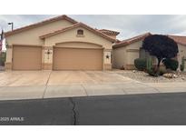 Charming single-story home featuring a two-car garage and desert landscaping at 17939 N Encanto Dr, Surprise, AZ 85374