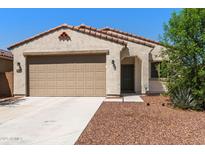 Charming single-story home with a two-car garage, neutral stucco, and a tile roof at 238 W Kona Dr, Casa Grande, AZ 85122