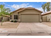 Charming single-story home with a tile roof, desert landscaping, and a spacious two-car garage at 2629 E Beverly Rd, Phoenix, AZ 85042