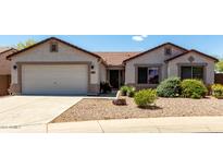 Charming single-story home featuring a low-maintenance desert landscape and attached two-car garage at 30 S 230Th Ave, Buckeye, AZ 85326