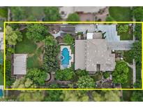 An aerial view of a sprawling property with a large pool, lush landscaping, and expansive living spaces at 3011 E Morrison Ranch Pkwy, Gilbert, AZ 85296