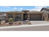 Charming single-story home with desert landscaping and a two-car garage at 32497 N 135Th Dr, Peoria, AZ 85383