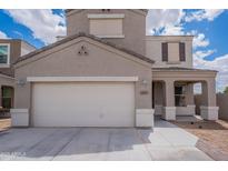 Two-story home featuring a two-car garage, covered front porch, and neutral-colored stucco exterior at 4205 W Maggie Dr, San Tan Valley, AZ 85144