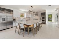 Bright and modern kitchen featuring a large center island, stainless appliances, and sleek cabinetry at 523 W Vista Ave, Phoenix, AZ 85021