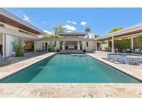 Inviting backyard pool and spa with a travertine deck, offering relaxation and entertainment in a private outdoor setting at 523 W Vista Ave, Phoenix, AZ 85021