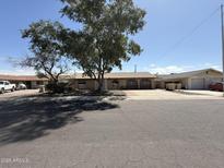 Charming single-story home featuring a well-maintained front yard and a welcoming facade at 8115 N 56Th Ave, Glendale, AZ 85302