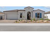 Charming single-story home with stucco exterior, landscaped yard, and inviting arched entryway at 12327 W Luxton Ln, Avondale, AZ 85323