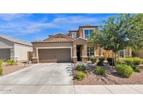 Inviting two-story home with a neutral color palette, tiled roof, desert landscaping and a two car garage at 1957 W Yellowbird Ln, Phoenix, AZ 85085