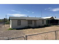 Modest single-story home with a brick facade and chain-link fence in a residential neighborhood at 3155 E Mobile Ln, Phoenix, AZ 85040