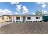 Charming home featuring a desert landscape, covered parking, and gray trim at 5328 E Yale St, Phoenix, AZ 85008