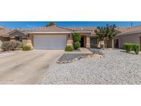 Inviting single-story home featuring a well-kept yard, desert landscaping and an attached two-car garage at 960 W Hudson Way, Gilbert, AZ 85233