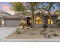 Charming home featuring mature landscaping, a two-car garage, and a tiled roof at 10478 E Sheena Dr, Scottsdale, AZ 85255