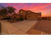 Charming two-story home with an attached two-car garage and low maintenance desert landscaping at 12473 W Montgomery Rd, Peoria, AZ 85383