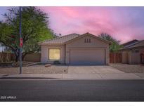 Charming single-story home featuring a well-maintained yard and two car garage at 13337 W Evans Dr, Surprise, AZ 85379