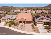 An aerial shot of a landscaped house featuring a tile roof, desert landscaping, and a two-car garage at 30876 N 128Th Dr, Peoria, AZ 85383