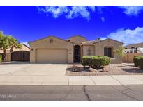 Charming single-story home with a two-car garage, desert landscaping, and neutral color palette at 40853 W Bravo Dr, Maricopa, AZ 85138