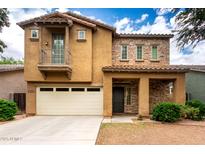 Charming two-story home featuring a stone facade, balcony, well-maintained landscaping and a two car garage at 4368 E Cullumber St, Gilbert, AZ 85234
