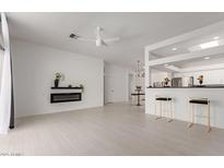 Spacious living room featuring a modern fireplace and open access to the kitchen at 7006 E Jensen St # 40, Mesa, AZ 85207