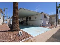 Charming manufactured home featuring a covered carport and low-maintenance landscaping at 7807 E Main St # F-35, Mesa, AZ 85207