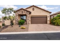 Charming home featuring a stone facade, a two-car garage, and desert landscaping for low maintenance at 8804 E Ivy St, Mesa, AZ 85207