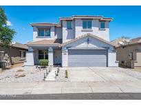 Charming two-story home featuring a well-manicured front yard and a two-car garage at 9110 W Palm Ln, Phoenix, AZ 85037
