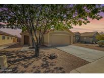 Charming single-story home featuring desert landscaping, neutral paint, and an attached two-car garage at 11359 E Elena Ave, Mesa, AZ 85208