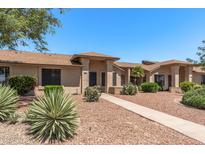 Charming home with desert landscaping, including gravel, shrubs, and a paved walkway leading to the front door at 13608 W Aleppo Dr, Sun City West, AZ 85375