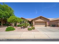 Charming single-story home with a well-maintained front yard and attached two-car garage at 17958 W Udall Dr, Surprise, AZ 85374