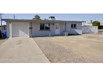 Charming single-story home with a covered front porch and attached one car garage at 2902 W Bloomfield Rd, Phoenix, AZ 85029