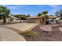 Charming home featuring a tile roof, spacious driveway, and desert landscaping with palm trees at 4616 E Gold Poppy Way, Phoenix, AZ 85044