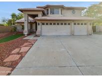 Charming home featuring a three-car garage, desert landscaping, and a tile roof at 5976 W Alameda Rd, Glendale, AZ 85310