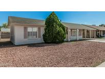 Charming single-story home with mature landscaping and a covered porch, offering curb appeal at 7345 W Beryl Ave, Peoria, AZ 85345