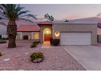 Charming single-story home features a lovely front yard and an attached two-car garage at 9009 E Sahuaro Dr, Scottsdale, AZ 85260