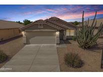 Charming single-story home featuring a two-car garage, low maintenance landscaping, and a beautiful Southwest-style desert view at 11004 E Delta Ave, Mesa, AZ 85208