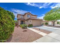 Charming two-story home with a well-manicured lawn and desert landscaping at 11301 W Glenrosa Ave, Phoenix, AZ 85037