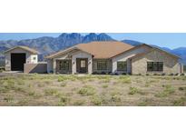 Charming single-story home boasting a tile roof, stone accents, and scenic mountain views at 14118 E Rancho Del Oro Ct, Scottsdale, AZ 85262