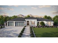 Beautiful single-story home featuring a modern facade, lush landscaping, and a three-car garage at 1835 N 103Rd St, Mesa, AZ 85207