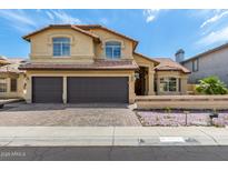 Charming two-story home with a tile roof, arched windows, and a well-manicured front yard at 20713 N 56Th Ave, Glendale, AZ 85308