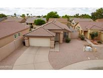 Charming single-Gathering home featuring a tile roof, low-maintenance landscaping, and a two-car garage at 2397 E Winchester Pl, Chandler, AZ 85286