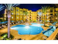 Nighttime shot of a well lit pool with palm trees, lounge chairs and a spa at 5450 E Deer Valley Dr # 3003, Phoenix, AZ 85054