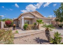 Inviting exterior view of home showing desert landscaping, palm trees and charming facade at 8010 W Adam Ave, Peoria, AZ 85382