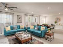 Bright and airy living room featuring stylish blue sofas, modern decor, and ample natural light at 8220 E Crestwood Way, Scottsdale, AZ 85250