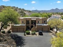 Beautiful desert home with neutral colors and desert landscaping, including a private drive and mountain views at 13850 N Mirage Heights Ct # 201, Fountain Hills, AZ 85268