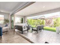 Inviting outdoor living area with comfortable seating and seamless connection to the indoors at 17168 W Mountainair St, Surprise, AZ 85388