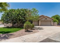 Charming single-story home featuring a well-manicured lawn, mature trees, and a spacious three-car garage at 1754 W San Tan St, Chandler, AZ 85224