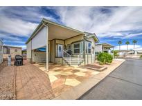 Charming single-Gathering home featuring an appealing exterior with manicured yard, driveway, and covered entrance at 7750 E Broadway Rd # 535, Mesa, AZ 85208