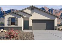 Charming single-story home with gray trim, desert landscaping, and a convenient two-car garage at 8440 W Clemente Way, Florence, AZ 85132