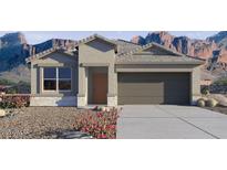 Charming single-story home featuring neutral color palette, low-maintenance landscaping, and a two-car garage at 8484 W Clemente Way, Florence, AZ 85132