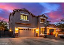 Beautiful two-story home featuring a large driveway, manicured landscaping, and a welcoming front porch at 9566 N 83Rd Dr, Peoria, AZ 85345